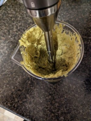samosa filling being blended in a cup with an immersion /stick blender